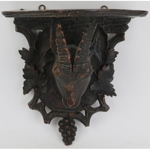 123 - A Black Forest carved wood wall bracket, 19th century. Carved depicting a goat enclosed by a grape a... 