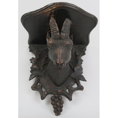 123 - A Black Forest carved wood wall bracket, 19th century. Carved depicting a goat enclosed by a grape a... 