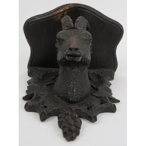 123 - A Black Forest carved wood wall bracket, 19th century. Carved depicting a goat enclosed by a grape a... 