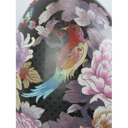 14 - A large Chinese cloisonné enamelled egg, 20th century. Decorated with an exotic bird amongst flowers... 