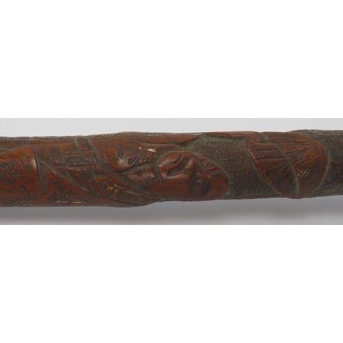 143 - A carved wood walking cane decorated with Japanese figures in a mountainous setting, late 19th/early... 