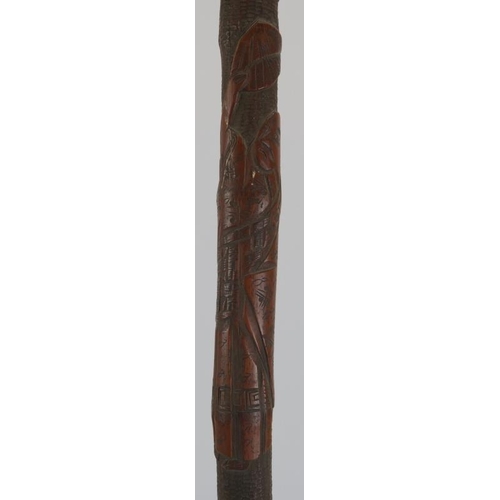 143 - A carved wood walking cane decorated with Japanese figures in a mountainous setting, late 19th/early... 