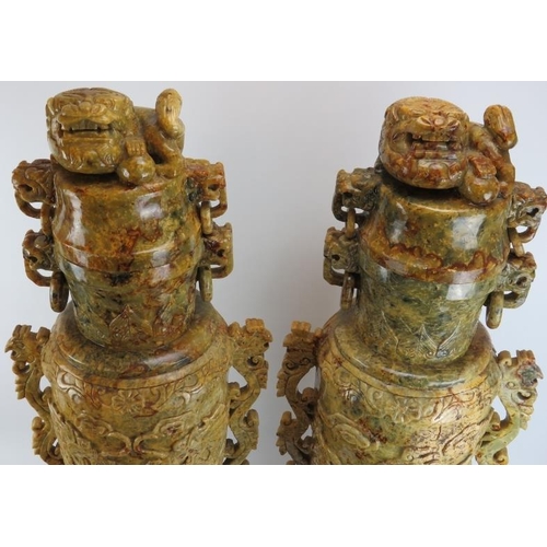 147 - A very large and impressive pair of Chinese carved stone vases and covers. Carved with Buddhistic li... 