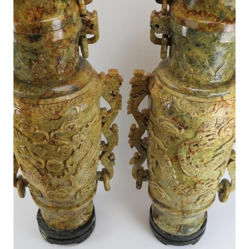 147 - A very large and impressive pair of Chinese carved stone vases and covers. Carved with Buddhistic li... 