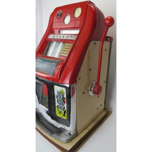 148 - An original vintage Mills three drum one arm bandit slot machine. Red enamelled and chrome mounts wi... 