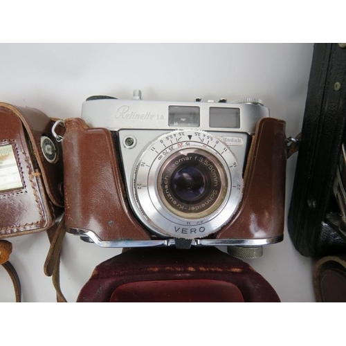 159 - A group of vintage cameras and binoculars. (5 items) Condition report: Some wear with age. Bentley’s... 