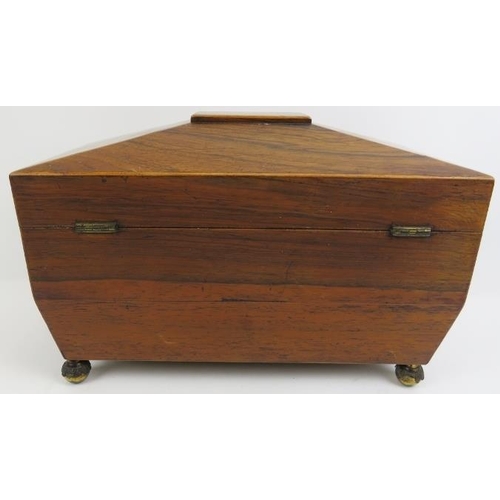 188 - A late Georgian rosewood tea caddy. Of sarcophagus form with twin handles, three internal compartmen... 