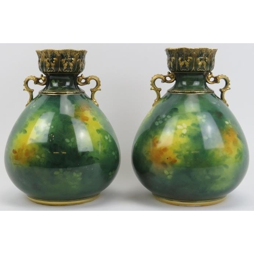 193 - A pair of German Royal Bonn twin handled vases. Both with gilt highlighted and hand painted decorati... 