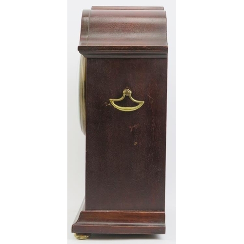 203 - An Edwardian mahogany inlaid mantle clock. With a marquetry inlaid mahogany case, circular bevelled ... 