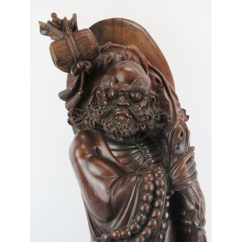 21 - A Chinese carved wood figure of an immortal, 20th century. 37 in (94 cm) height. 
Condition report: ... 