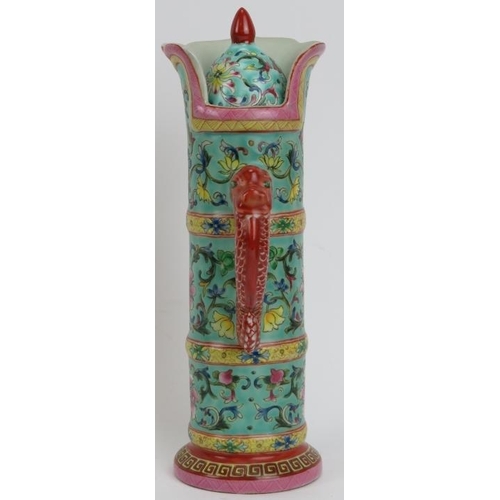 217 - An unusual Chinese famille rose enamelled hot water decanter and cover. The spout modelled with an o... 