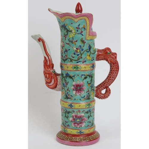 217 - An unusual Chinese famille rose enamelled hot water decanter and cover. The spout modelled with an o... 