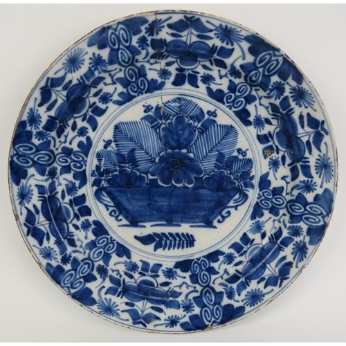 243 - A Dutch Delft blue and white charger, 18th century. Painted with a basket of flowers to the centre e... 