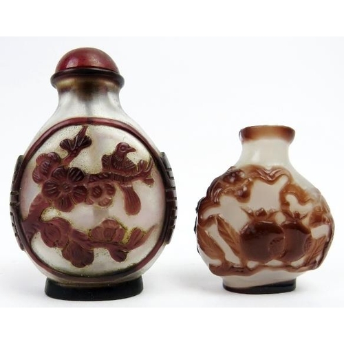 246 - Two Chinese overlay glass snuff bottles, late 19th/early 20th century. Both of ovoid form with ruby ... 