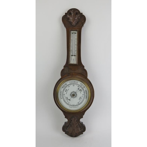 260 - A carved oak aneroid barometer, late 19th/early 20th century. Incorporated with a mercury thermomete... 