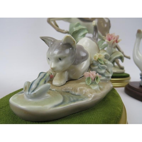 265 - A group of five Lladro figurines. Comprising a leaping gazelle, recumbent bull, recumbent donkey, go... 