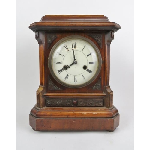 271 - A Victorian mahogany table clock, 19th century. With enamelled Roman numeral dial and supported on b... 