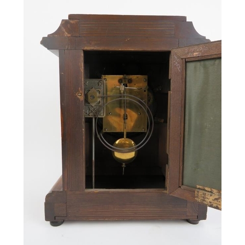 271 - A Victorian mahogany table clock, 19th century. With enamelled Roman numeral dial and supported on b... 