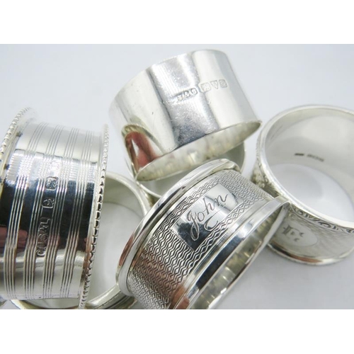 311 - A collection of six silver napkin rings to include a pair of George Unite & Sons, Birmingham 1928, o... 