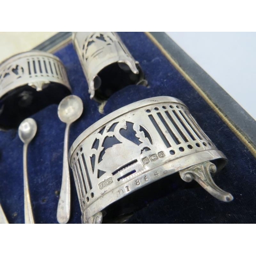 385 - A five piece silver condiment set with pierced & swan decoration with two silver salt spoons and a s... 