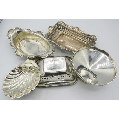 387 - An assortment of five silver bon bon dishes, to include a rectangular one with embossed & pierced de... 