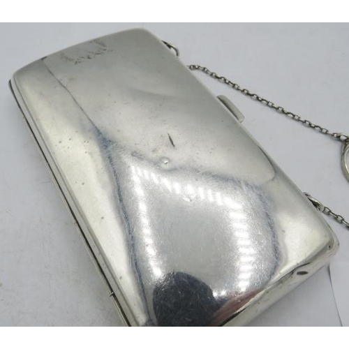 392 - A silver rectangular purse on a chain, Birmingham 1912, monogrammed, with green silk liner. Approx 5... 