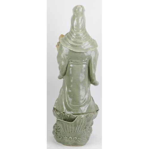 4 - A large Chinese celadon glazed porcelain figure of Guanyin, 20th century. Depicted standing holding ... 