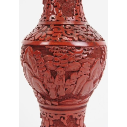 41 - A Chinese cinnabar lacquer vase. Decorated with a continuous figural, mountain landscape scene. 7.3 ... 