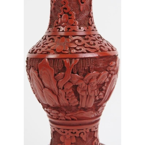 41 - A Chinese cinnabar lacquer vase. Decorated with a continuous figural, mountain landscape scene. 7.3 ... 