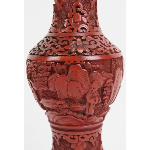 41 - A Chinese cinnabar lacquer vase. Decorated with a continuous figural, mountain landscape scene. 7.3 ... 