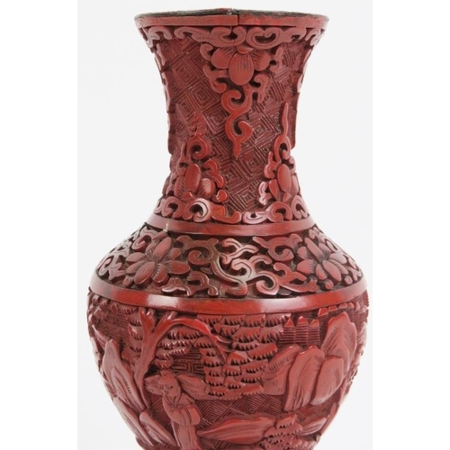 41 - A Chinese cinnabar lacquer vase. Decorated with a continuous figural, mountain landscape scene. 7.3 ... 