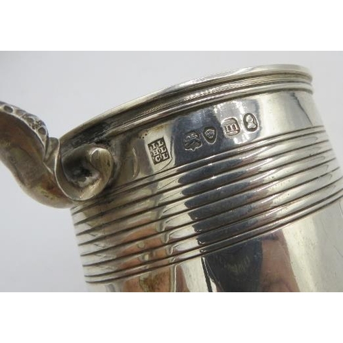 414 - A Georgian silver christening mug with double scroll acanthus leaf handle, monogrammed. Approx 3