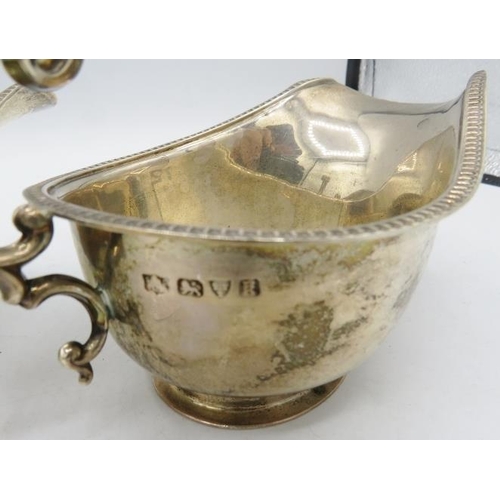 420 - A pair of silver sauce boats with double scroll acanthus leaf handles and pedestal foot, Chester 193... 