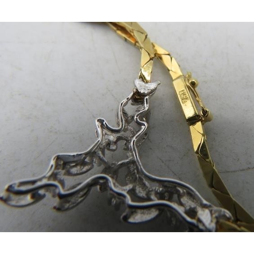 433 - An 18ct yellow & white gold delicate necklace. The centre design having leaf decoration and set with... 