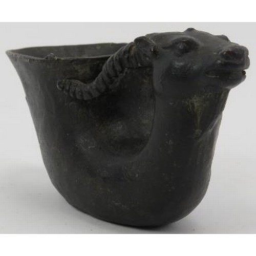 45 - A Chinese dark patinated bronze libation cup. Carved in the form of a ram. Ming dynasty mark beneath... 