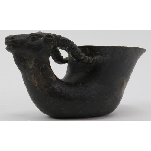 45 - A Chinese dark patinated bronze libation cup. Carved in the form of a ram. Ming dynasty mark beneath... 