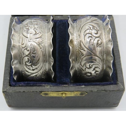 454 - A pair of embossed silver napkin rings, Birmingham hallmarks worn, boxed. Approx weight 1.1 troy oz/... 