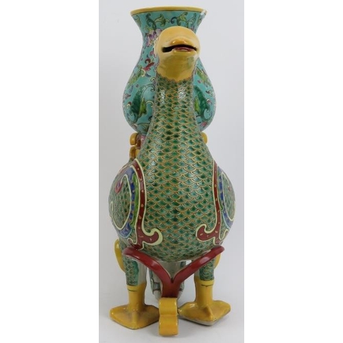 47 - A large Chinese polychrome enamelled porcelain duck, 20th century. Modelled as a duck carrying a vas... 