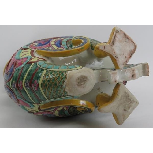 47 - A large Chinese polychrome enamelled porcelain duck, 20th century. Modelled as a duck carrying a vas... 