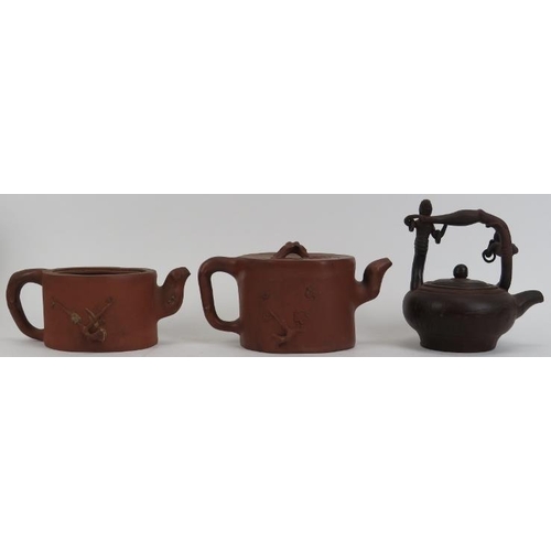 49 - A group of three Chinese Yixing pottery teapots. (3 items) 5.6 in (14.2 cm) tallest height. 
Conditi... 