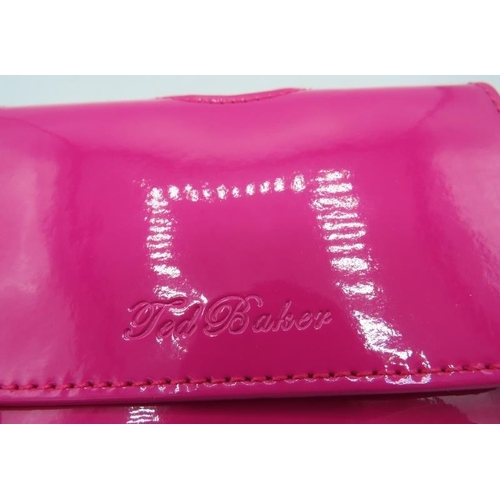 500C - A Ted Baker pink wallet, boxed.
Provenance: Part of a private collection of designer luxury goods bo... 