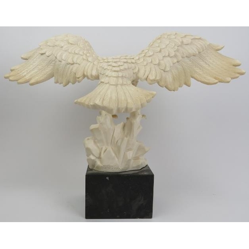 55 - A composite cast statue of an eagle, 20th century. Signed to the reverse and displayed on a marble p... 