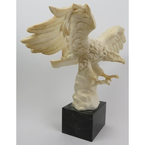 55 - A composite cast statue of an eagle, 20th century. Signed to the reverse and displayed on a marble p... 