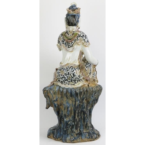 6 - A large Chinese figure of Guanyin, 20th century. depicted seated on a rock with the figure painted i... 