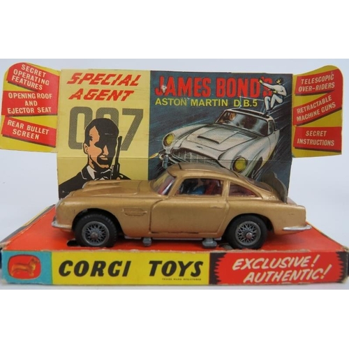 61 - Corgi Toys No. 261 James Bond Aston Martin DB5. Car with gold bodywork and red interior, working mec... 