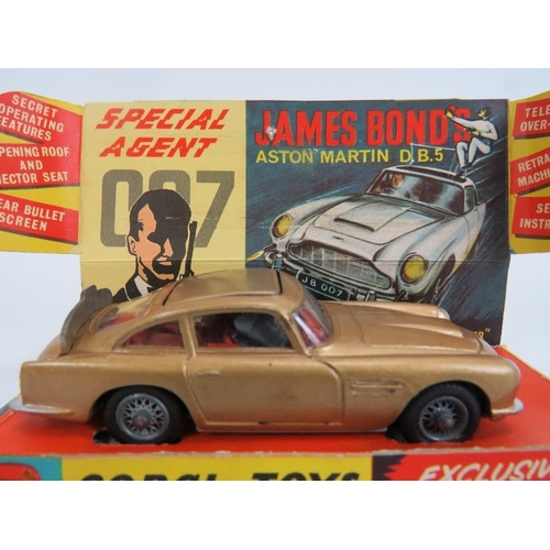 61 - Corgi Toys No. 261 James Bond Aston Martin DB5. Car with gold bodywork and red interior, working mec... 