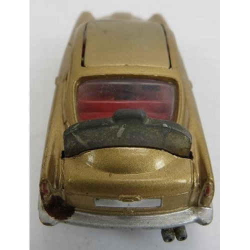 61 - Corgi Toys No. 261 James Bond Aston Martin DB5. Car with gold bodywork and red interior, working mec... 