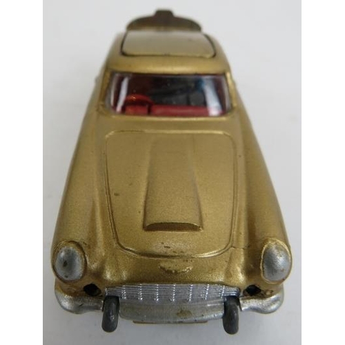 61 - Corgi Toys No. 261 James Bond Aston Martin DB5. Car with gold bodywork and red interior, working mec... 