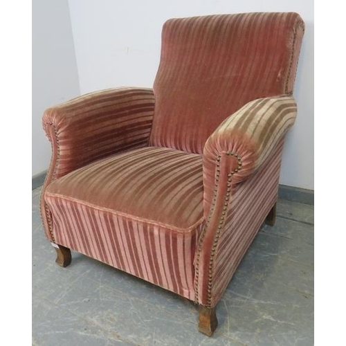 866 - An antique French club armchair upholstered in brown striped velveteen material with brass studs, on... 