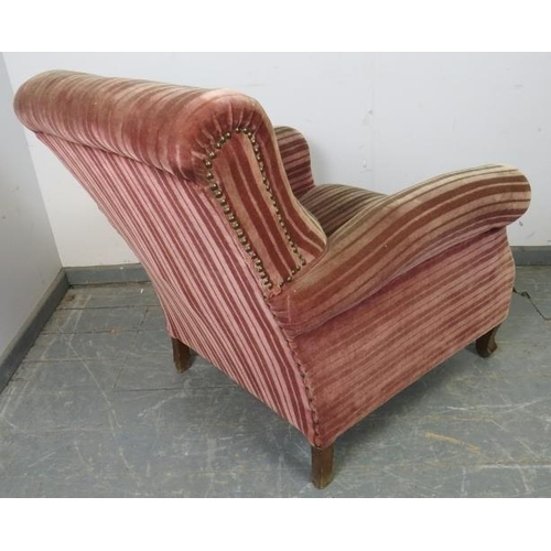 866 - An antique French club armchair upholstered in brown striped velveteen material with brass studs, on... 